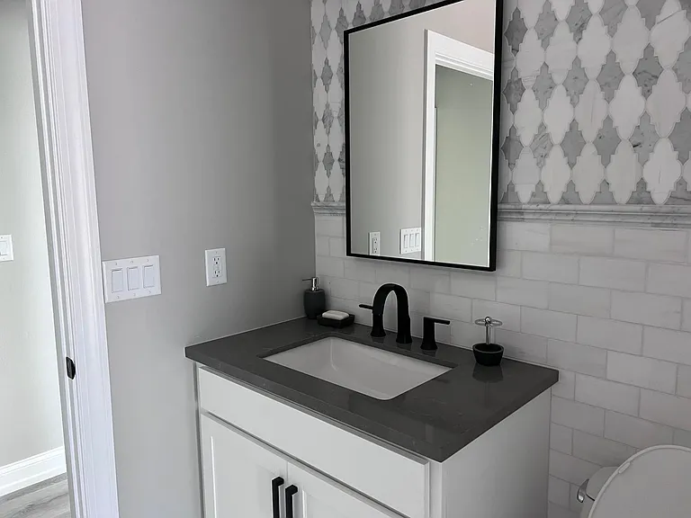 Powder Room off Kitchen with full shower and access to pool