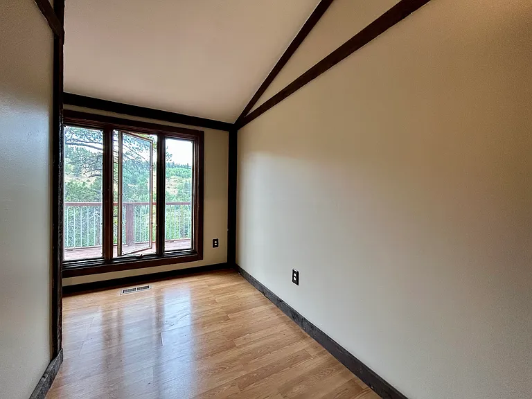 High vaulted ceilings and mountain views with 7 ft windows in the guest/office room