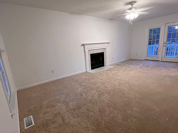Large living room/family room with french doors leading to deck.