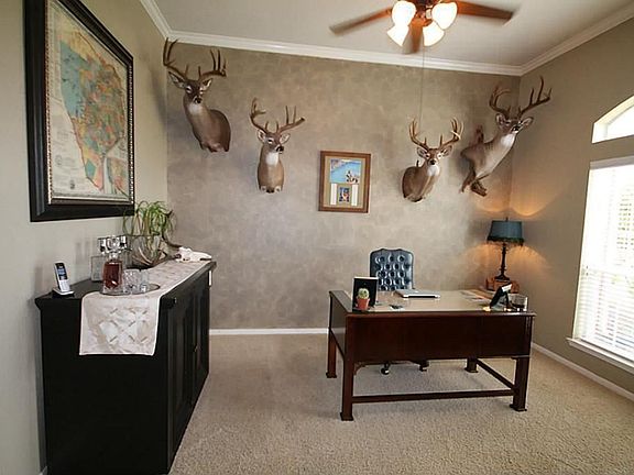 To the right of the entry is a study with dramatic ceilings.