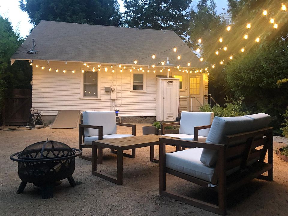 Spacious backyard with outdoor lighting.