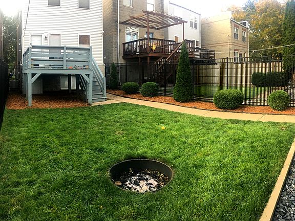 LARGE FENCED IN BACKYARD WITH FIRE PIT
