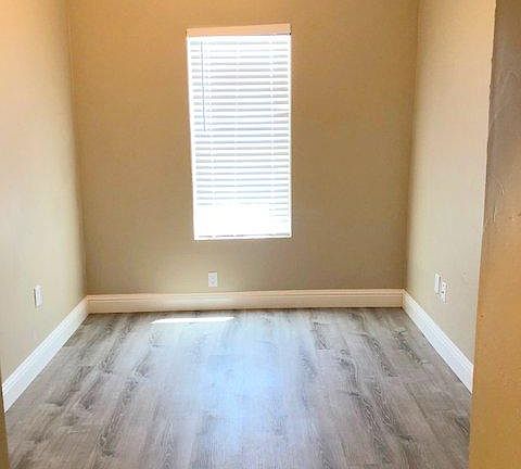 Bedroom with vaulted ceilings and laminate floors