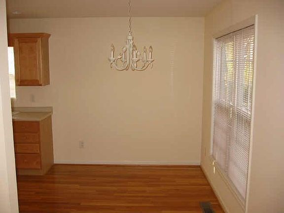 Dining room area with chandelier flows into kitchen.