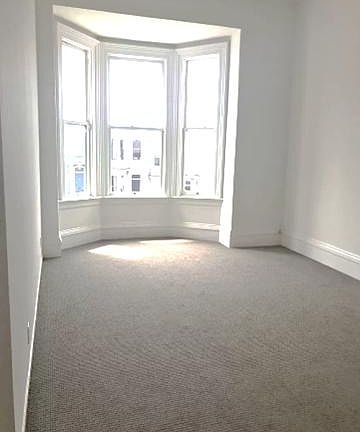 Front Family/Living Room: The large room, has a lot of natural light. It has bay windows, new flooring and high vaulted ceilings.