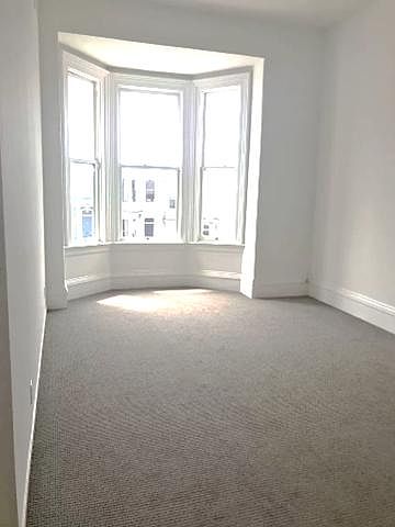 Front Family/Living Room: The large room, has a lot of natural light. It has bay windows, new flooring and high vaulted ceilings.