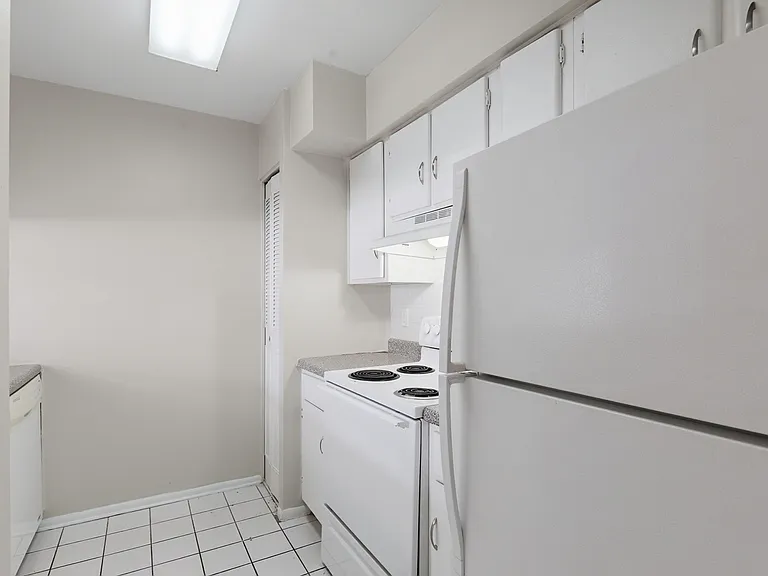 Elevate your lifestyle at Wymore 360 Apartments. This modern kitchen features sleek white cabinetry and plenty of space for culinary creativity. Enjoy convenience and comfort in every corner. Schedule your tour today!