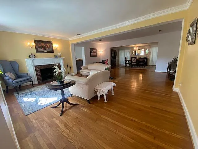 Living room with fireplace, center room, and formal dining room. The "library" is just off the left of the center room (you can see the doorway) - 2234 N Albemarle St