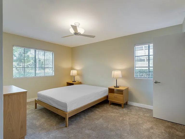 Furnished+ apartment homes feature queen bed with mattress, dresser, nightstands, and lamps (Representative Image exact items and style of furnishings may vary)
