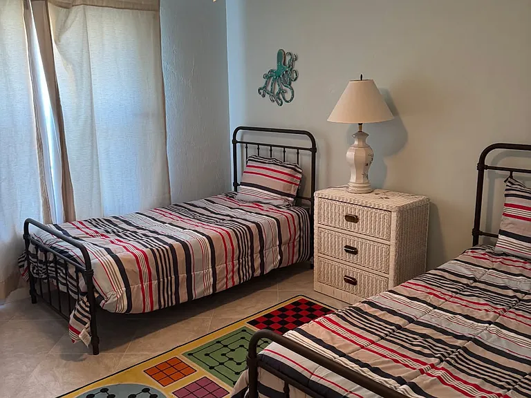 Second bedroom with twin beds. tile floor. large closet