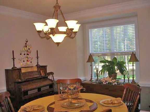 Spacious Formal Dining Room has gleaming hardwood floors & updated fixtures
