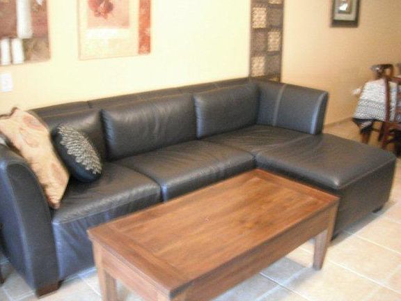 Leather sectional, bright living area with large AC