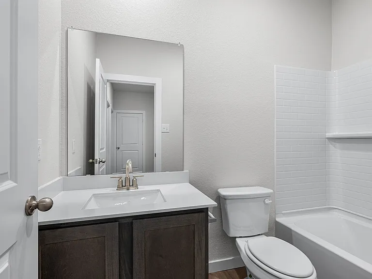 The secondary bathroom has a sprawling vanity space.