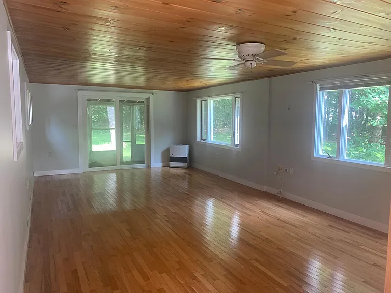 Living room & slider to backyard. Efficient K-1 Rinnai heater (one of two).