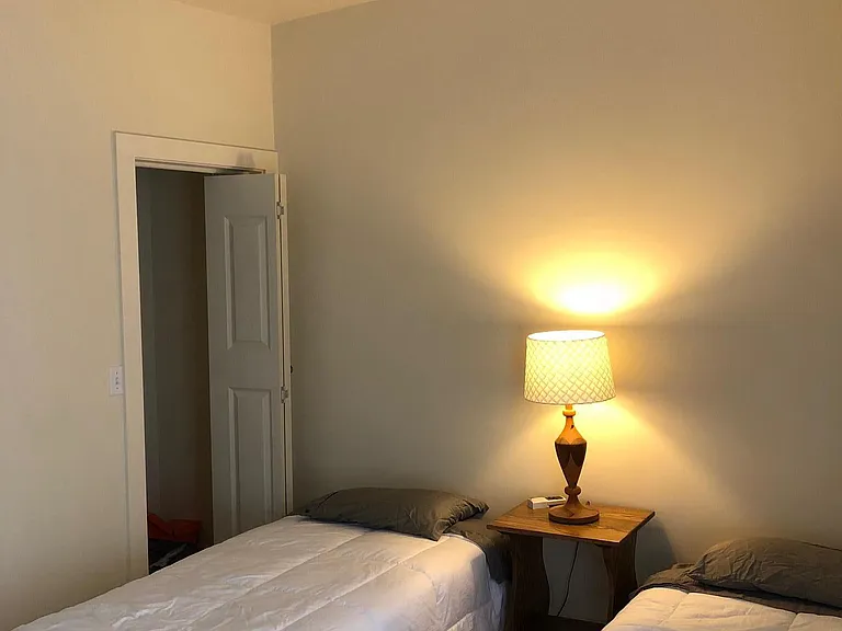 Small bedroom with overhead fan and closet for storage