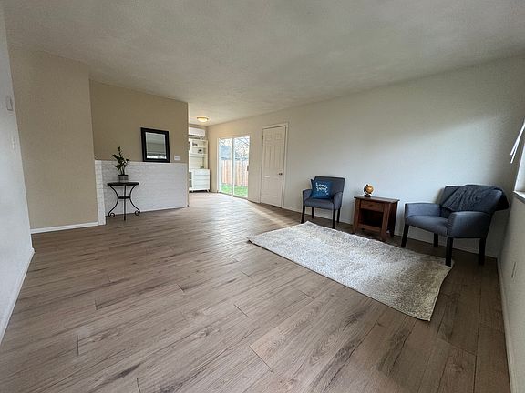 The living room features new flooring, new paint, a mini-split unit for climate control, and lots of light!