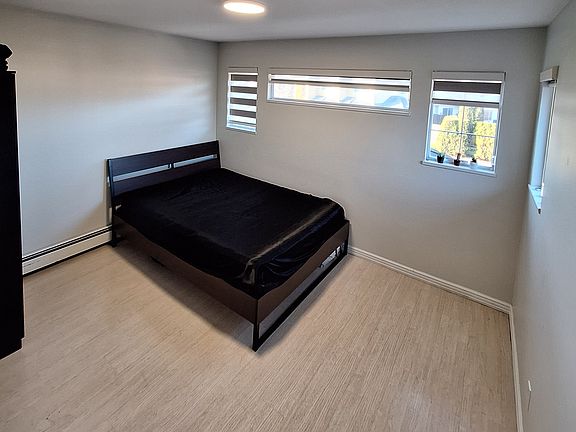 Bedroom. Has multiple windows on both walls. It comes with a closet.