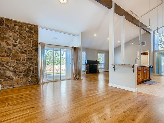 Open kitchen and living area. Two slider doors. Abundant natural light. Laundry and half-bath accessed at far end of this photo.
