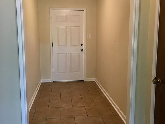 Front door entry. Door on the right is a coat closet.
