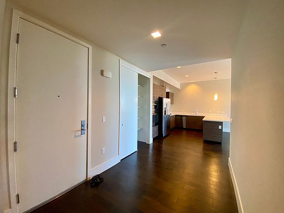 Entry with Coat Closet/Pantry and View of Kitchen