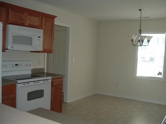 KITCHEN VIEW SHOWING EAT-IN KITCHEN AREA (front door to left)