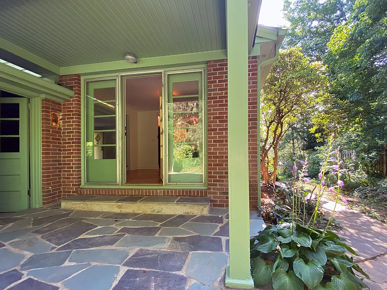 Back patio with door to garage and dining room entrance