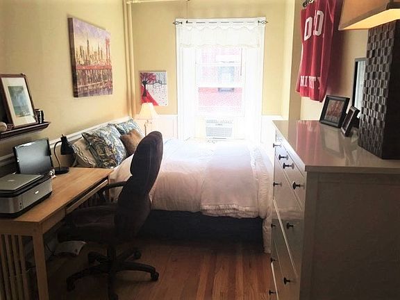 Bedroom with Queen bed, desk, dresser and customized closets