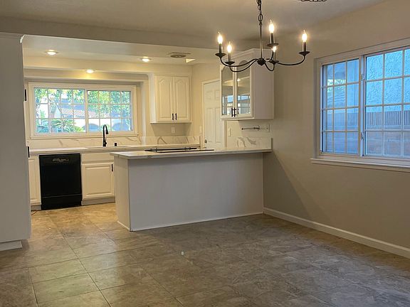Eat in the dining room or slip your stools under the counter tops. New chandelier, countertops, faucet and sink.