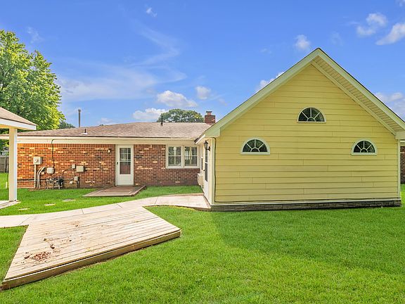 Rear view of property with studio building on left