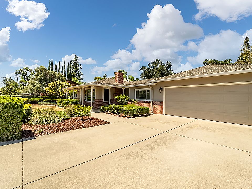 Large driveway, two-car garage, side driveway to back lot.