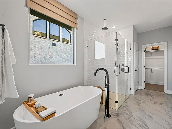 Primary bath with freestanding tub and glass shower enclosure