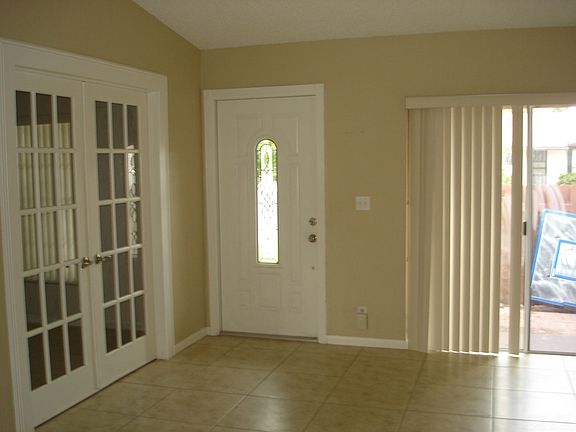 Front door and 3rd bedroom with french doors
