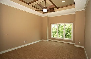Master bedroom has custom wood featured ceiling and wall of windows!
