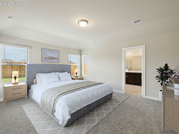 The primary bedroom of a home in Wall Street Village of Richmond, TX.