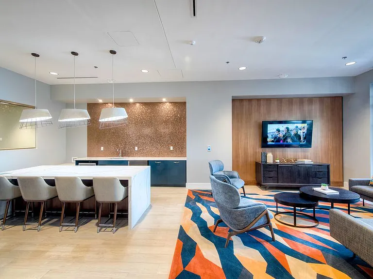Resident lounge with entertaining kitchen, seating and flat screen television