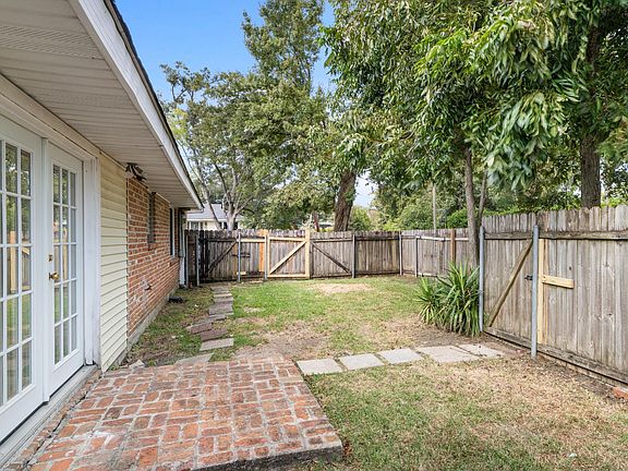 Side yard with gated entrance to Parking