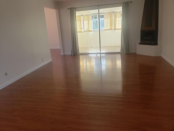 Living room leading to enclosed back porch.