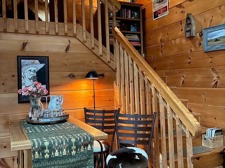 Stairs to Loft area with Half Bathroom. Partially open for added privacy. Twin day bed. Fold out twin bed with 4 inch memory foam mattress. Desk. TV.