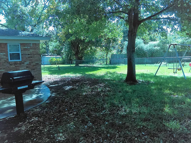 Fenced shaded backyard