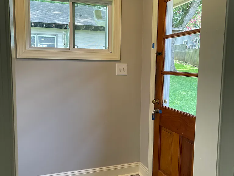 Back entrance. Door has been replaced with new steel door with window. Laundry is enclosed directly across from the back door.
