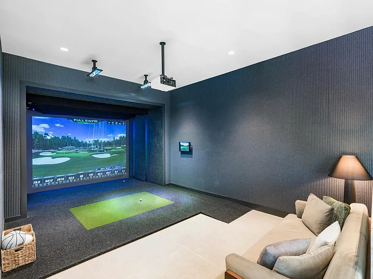Practice your swing in the indoor golf simulator lounge_perfect for a casual round or sharpening your game.