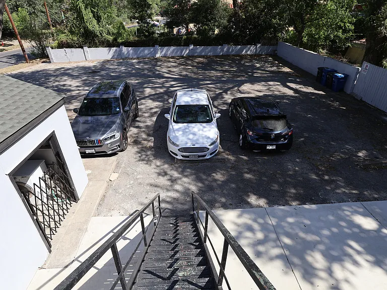 Private off street, tree-lined parking lot.