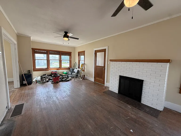 Hardwood floors are being refinished. Fireplace is non-functional.