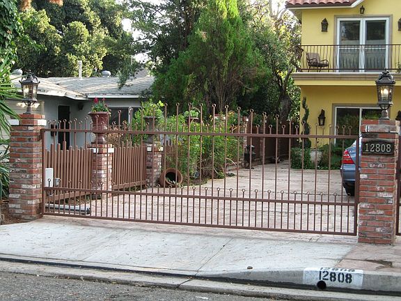 Artisan crafted wrought iron driveway gate