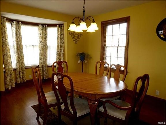 Dining room with original hardwood and bay window.