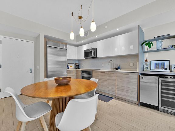 Kitchen and dining space with ice maker and wine fridge, dishwasher, oven, stove top and fridge