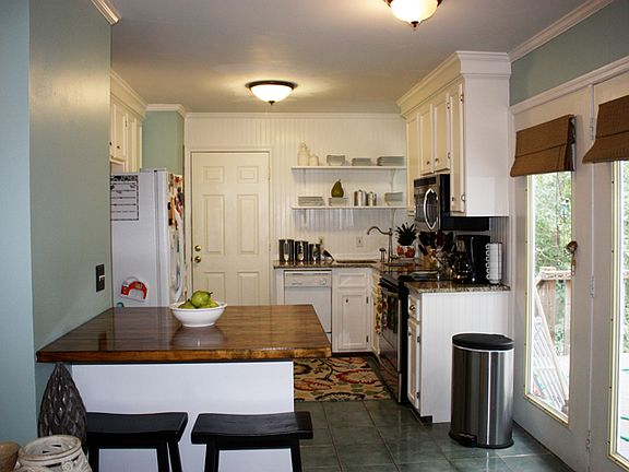 Newly renovated kitchen with granite countertops & butcher block island top