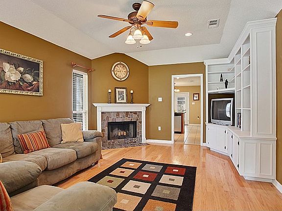 Den Features Custom Built-ins &amp; Corner Fireplace.