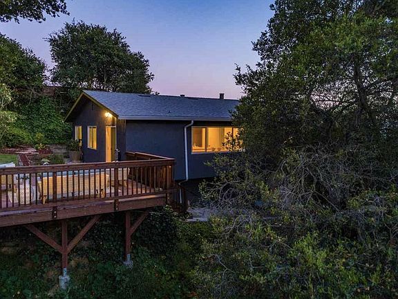 Treetop deck overlooking creek, window is into kitchen and breakfast island