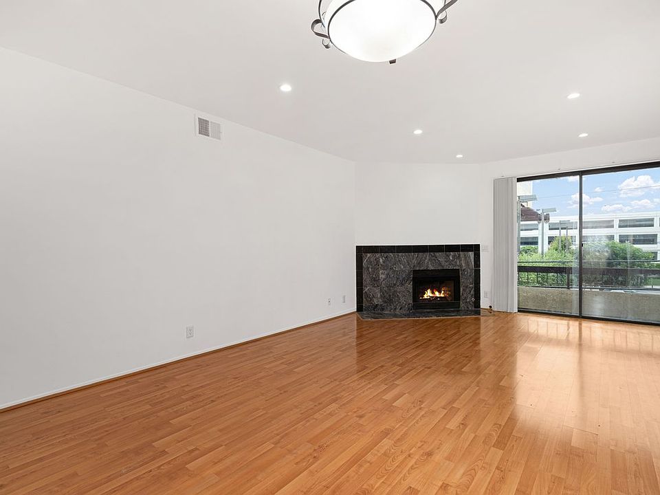 Living room, view 1 - from foyer with view of fireplace & balcony.